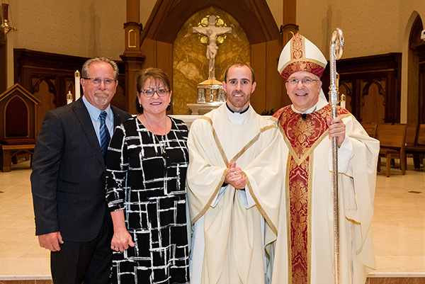 Father Adam Maher with parents and Bishop