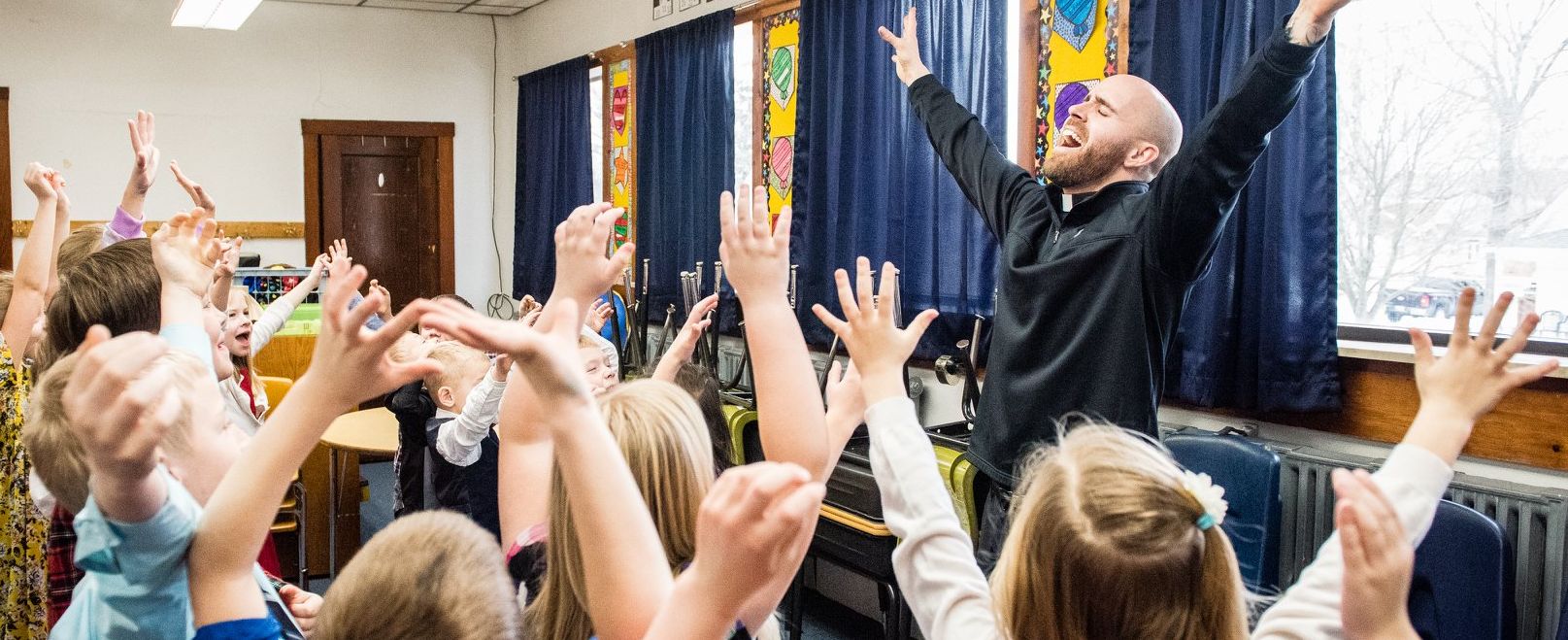 father adam celebrating with kids