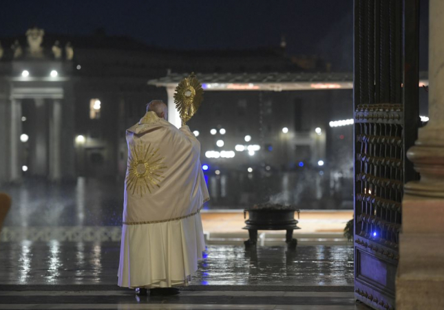 Pope Francis blesses the City of Rome and the World, holding the monstrance on the steps of St. Peter's Basilica in Rome.