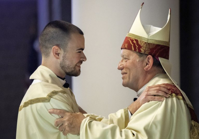 gruss kevin wojo embrace during ordination