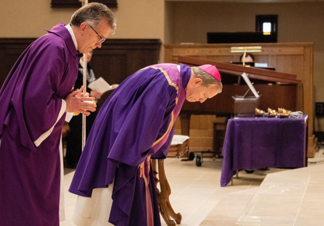 Deacon Rick Warner (left) and Bishop Robert Gruss bow before the altar during the Mass of Atonement at the Cathedral of Mary of the Assumption in Saginaw on March 29, 2022. 