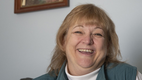 COVID-19 survivor Tammy Heinlein looks at a prayer quilt at her home in Reese. The quilt was made for her while she was in the hospital last year.