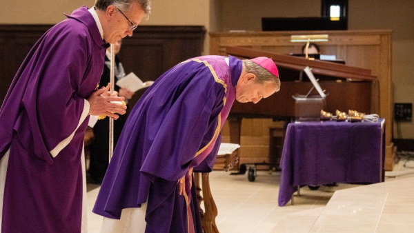 Deacon Rick Warner (left) and Bishop Robert Gruss bow before the altar during the Mass of Atonement at the Cathedral of Mary of the Assumption in Saginaw on March 29, 2022. 