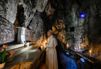 Pope Leo XIV lights a candle and prays in the Cave of St. Benedict at the Shrine of Our Lady of Grace of Mentorella near Guadagnolo, Italy, Aug. 19, 2025
