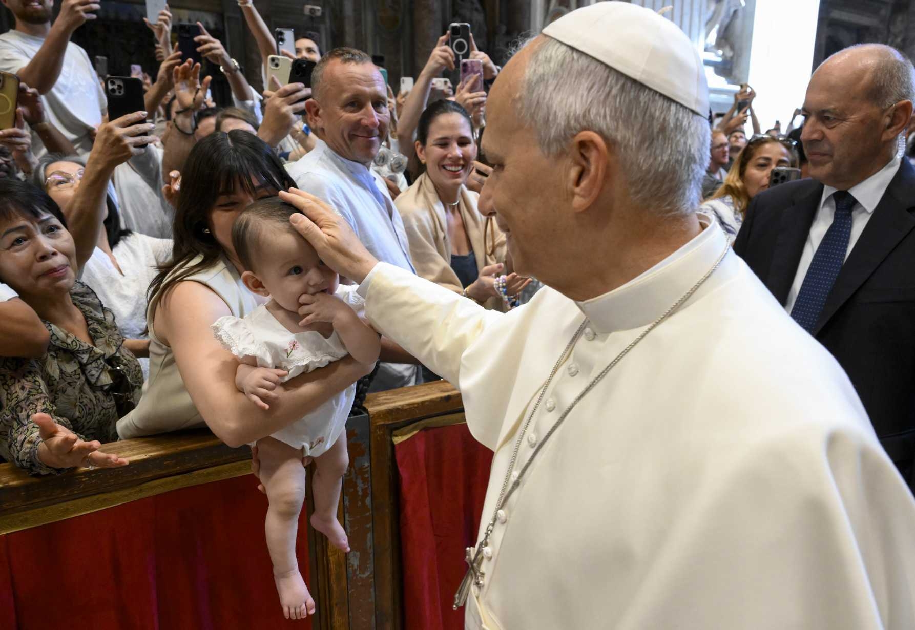 Pope Leo XIV greets a baby and family 