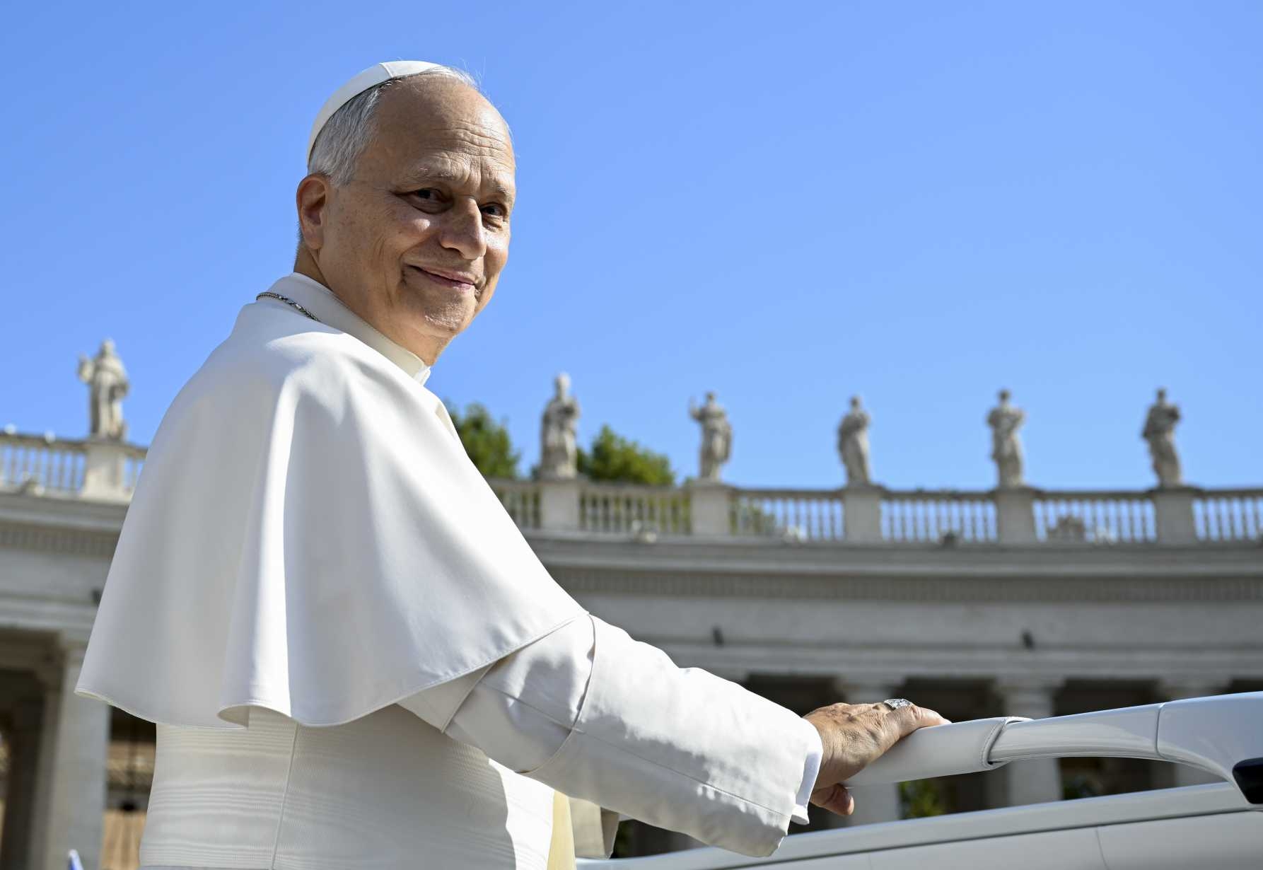Pope Leo XIV smiles as he greets visitors