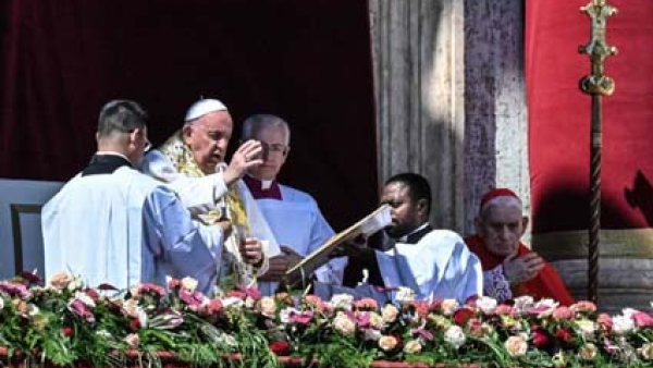 Pope Francis gives his blessing "urbi et orbi" (to the city and the world) from the central balcony of St. Peter's Basilica at the Vatican after celebrating Easter morning Mass April 9, 2023.