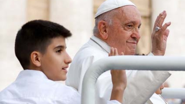 Pope Francis, and one of his young passengers in the popemobile