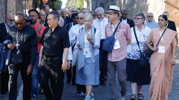 Participants in the assembly of the Synod of Bishops walk 