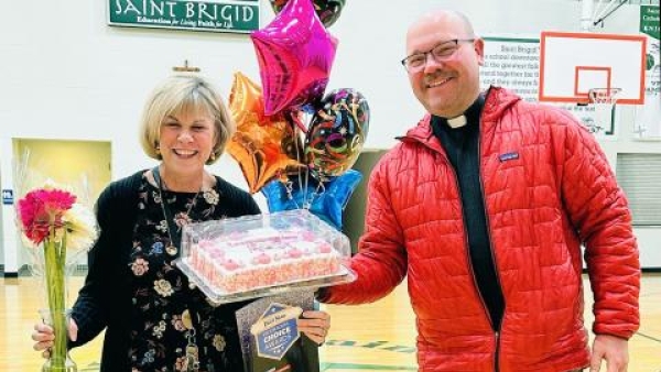  Susie Hollingshead of St. Brigid Catholic School with Fr. Booms