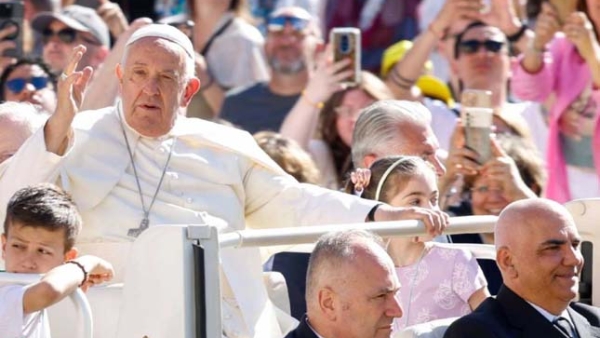 Pope Francis greets visitors as he rides the popemobile around St. Peter's Square