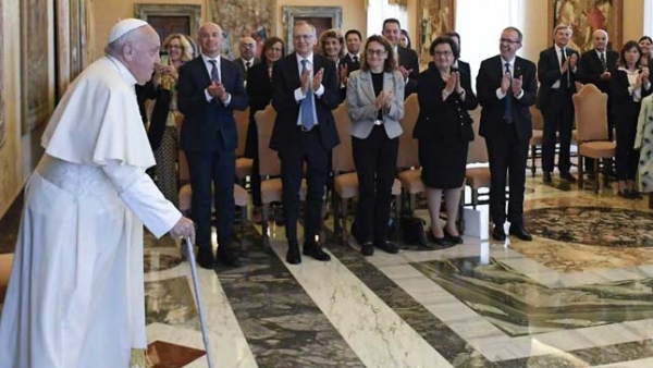 Pope Francis greets a group of scholars participating in a conference