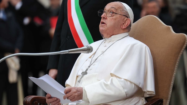 Pope Francis looks up at a Marian statue atop a column near the Spanish Steps in Rome before he prays to Mary Dec. 8, 2024, the feast of the Immaculate Conception.