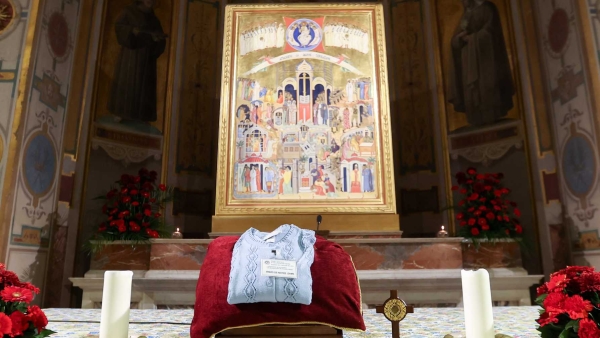 A cross containing blood-stained dirt from the site in the Amazon where Notre Dame de Namur Sister Dorothy Stang was killed in 2005, along with one of her sweaters, sits on the main altar before a prayer service at the Church of St. Bartholomew on Tiber Island in Rome