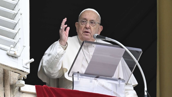 Pope Francis gives his blessing to people gathered in St. Peter's Square at the Vatican for the recitation of the Angelus prayer Jan. 12,