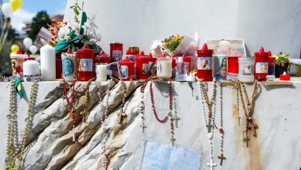 Devotional items are seen at the base of a statue of St. John Paul II outside of Rome's Gemelli hospital March 16, 2025