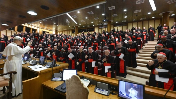 Pope Leo XIV prays with the College of Cardinals in the New Synod Hall at the Vatican May 10, 2025