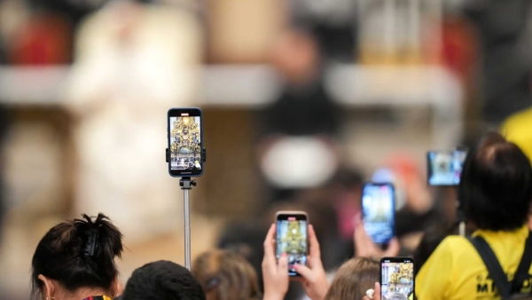 People use their cellphones to record Pope Leo XIV as he addresses them during the Jubilee of Digital Missionaries