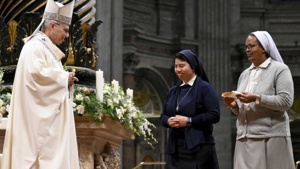 Pope Leo XIV receives the offertory gifts during Mass with consecrated women