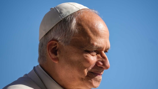 Pope Leo XIV smiles as he greets visitors